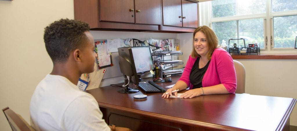 Financial aid counselor talking with student